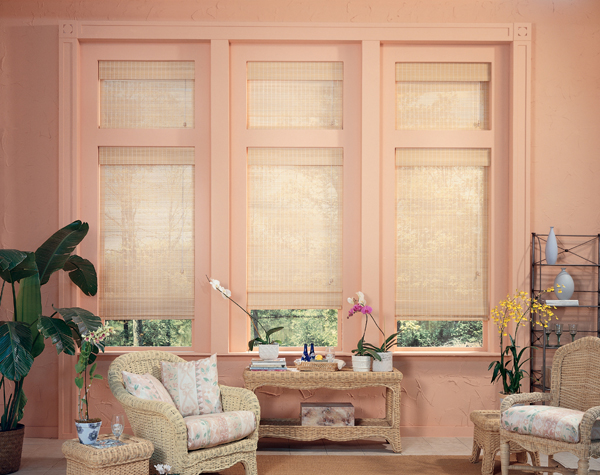 Sunroom with woven shades on a wall of windows