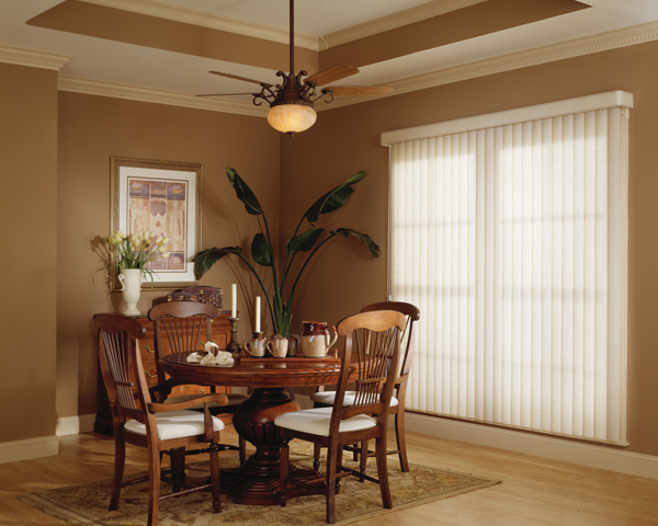 Dining room with sheer shades on large windows