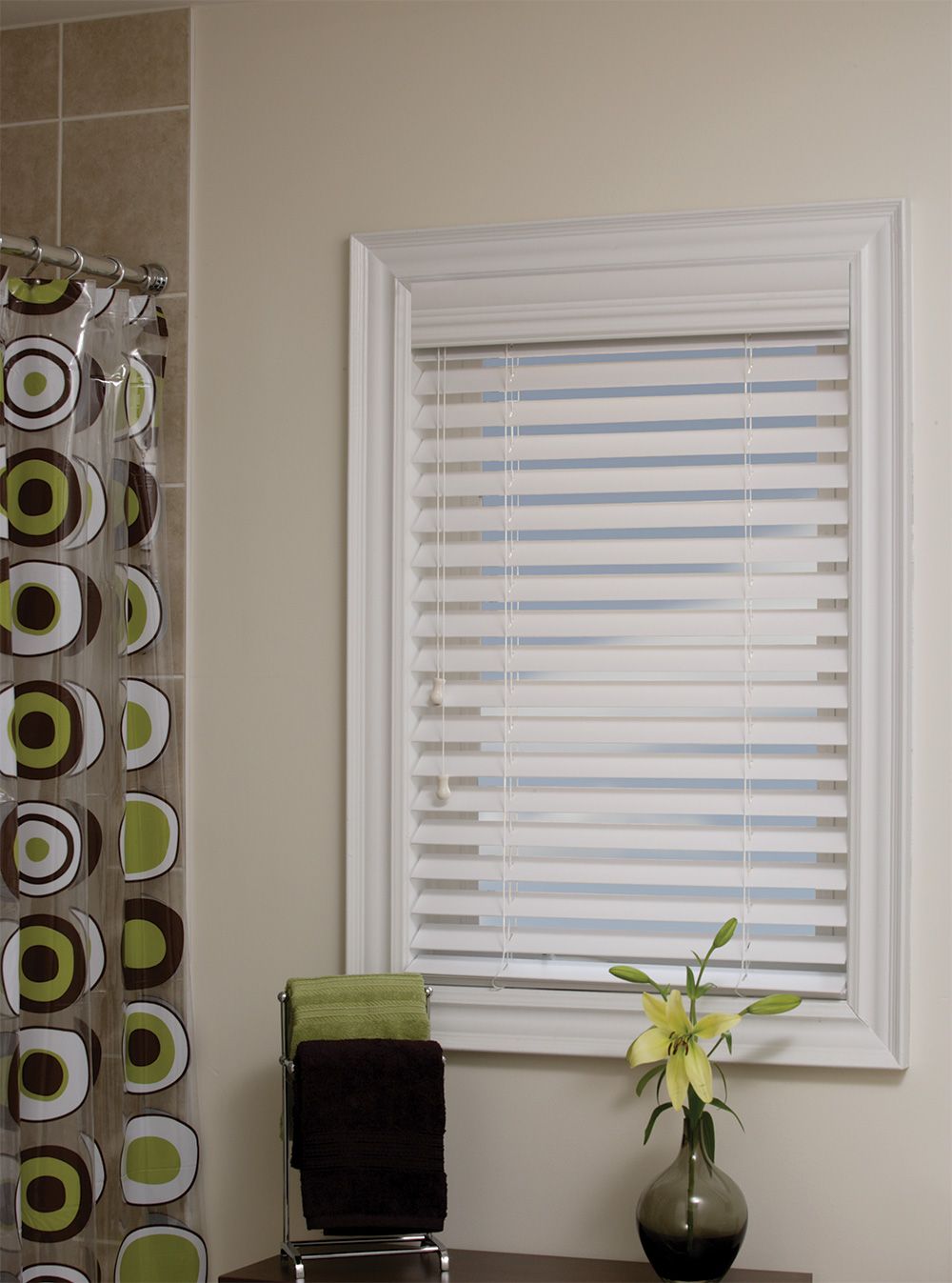 White faux wood blind in a bathroom